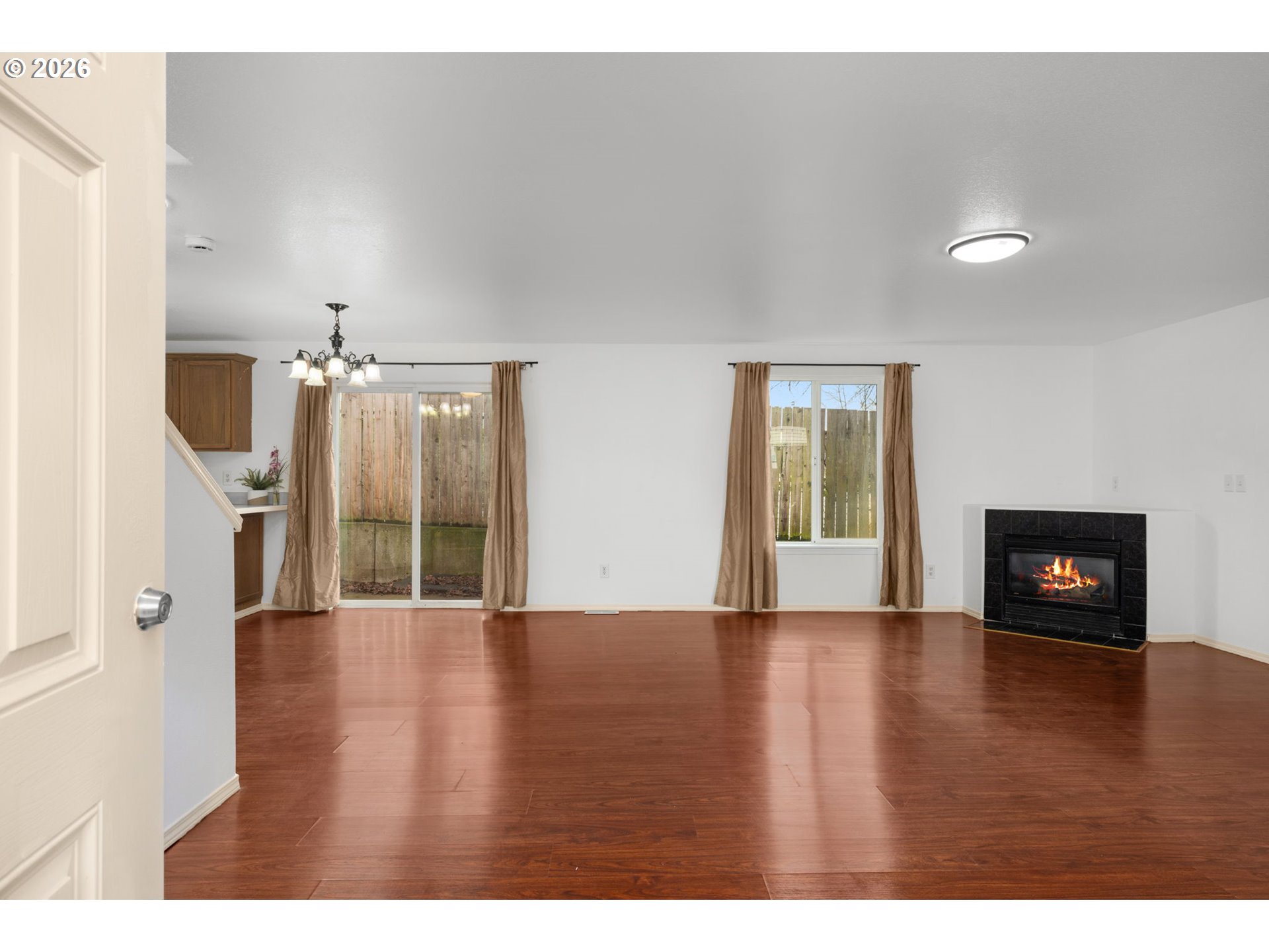 8704 Southeast Rhone Street Portland, OR 97266 - Photo 4 of 24 a view of an empty room with window and wooden floor