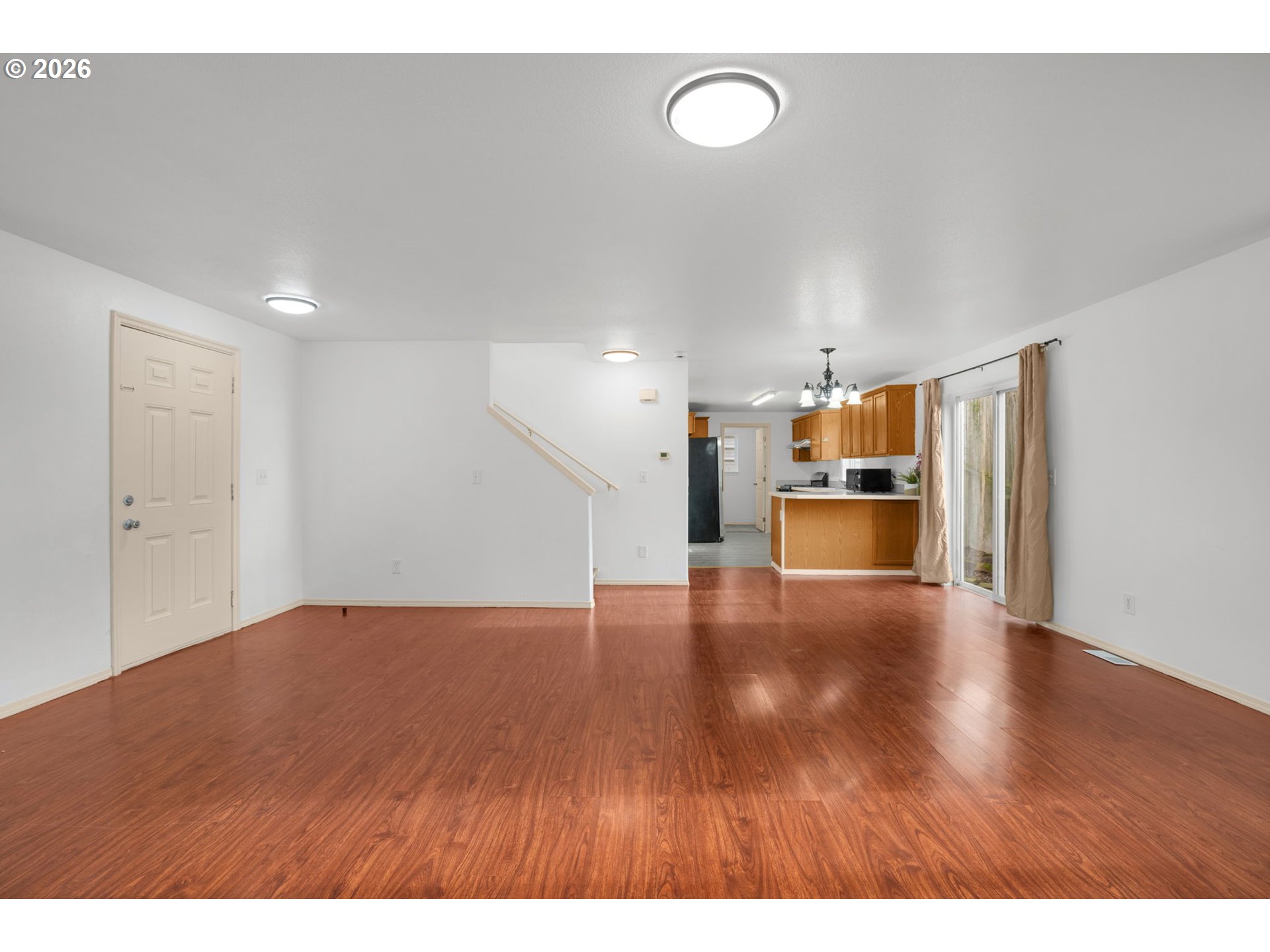8704 Southeast Rhone Street Portland, OR 97266 - Photo 7 of 24 a view of empty room with wooden floor