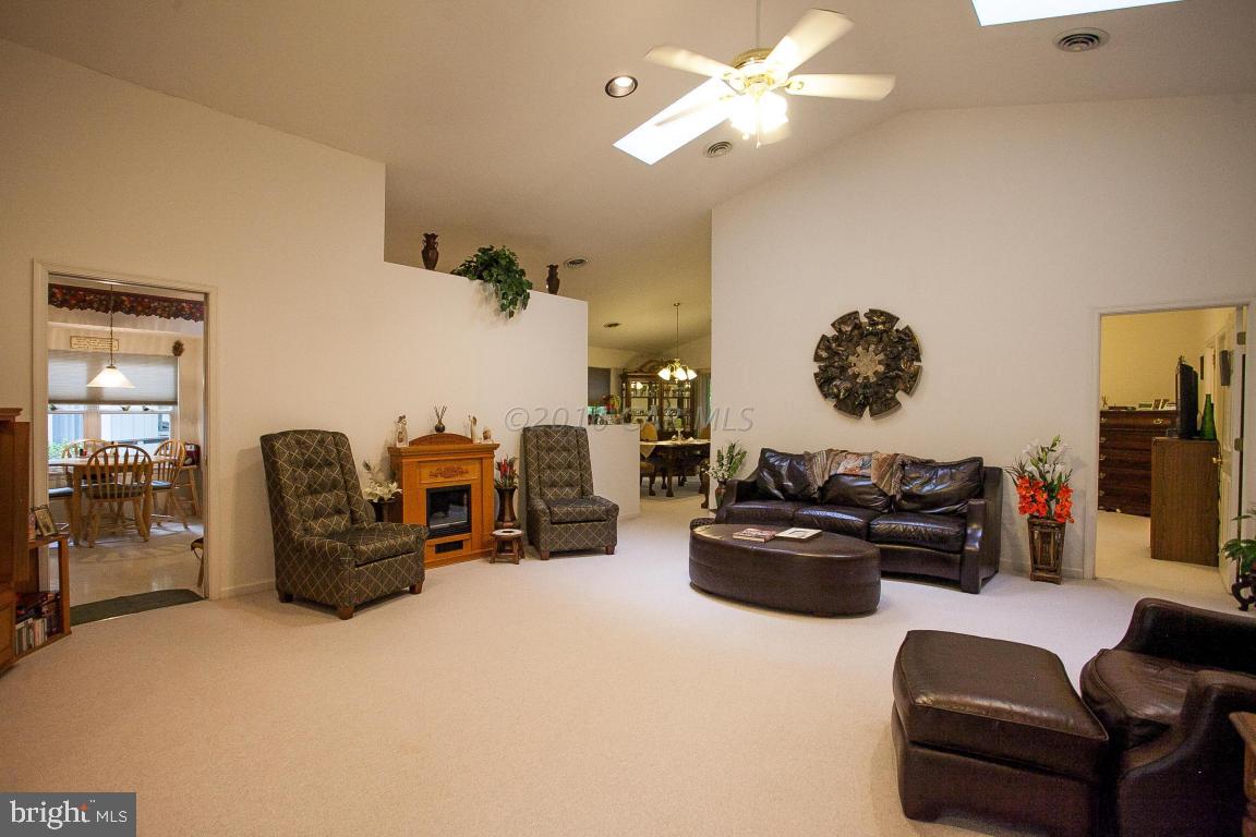 133 Pinehurst Road Berlin, MD 21811 - Photo 13 of 112 a living room with furniture a chandelier and a flat screen tv