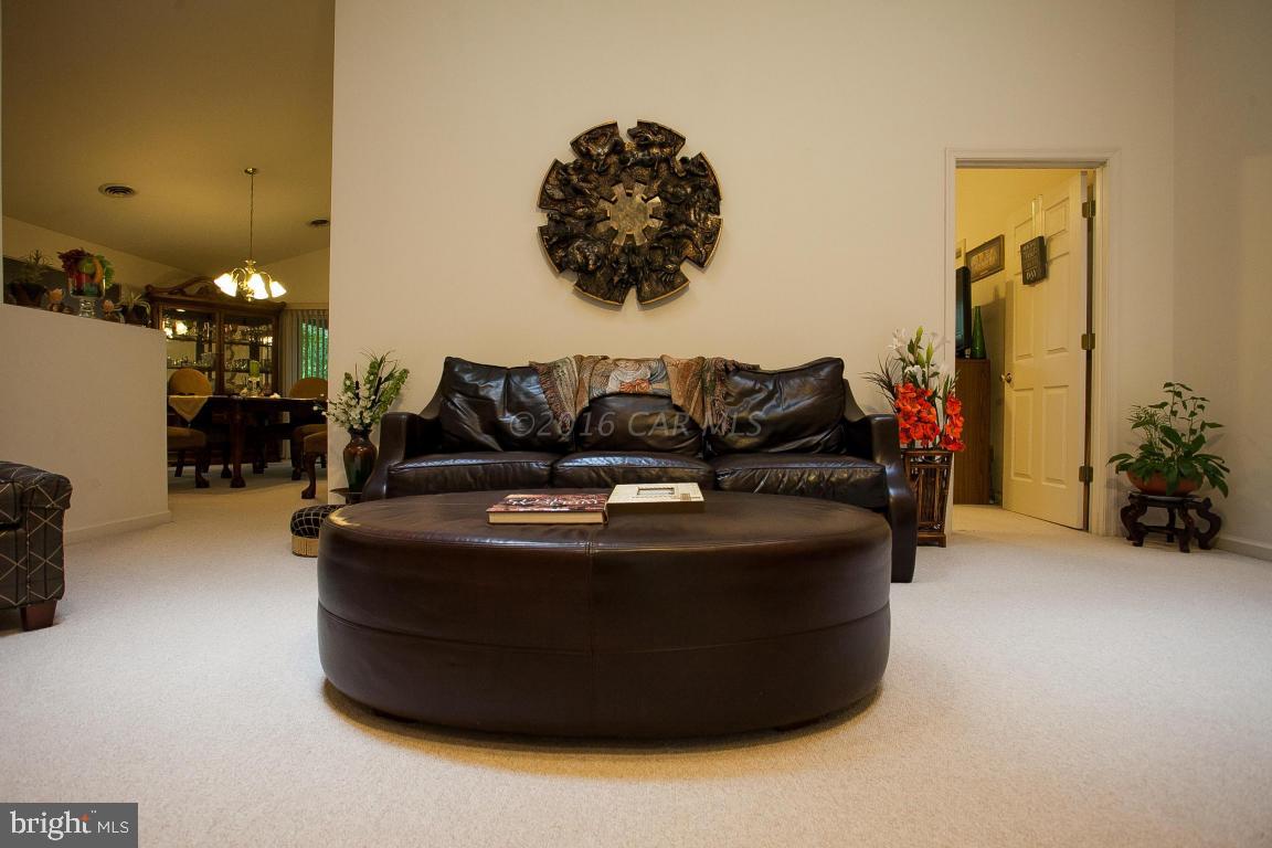 133 Pinehurst Road Berlin, MD 21811 - Photo 15 of 112 a living room with furniture and a chandelier