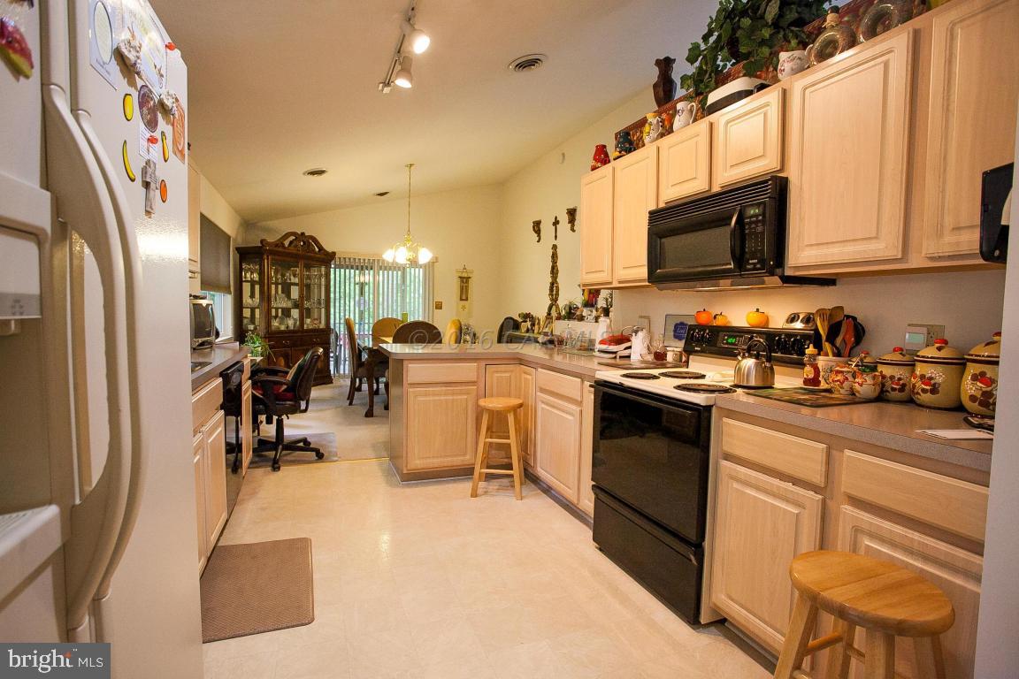 133 Pinehurst Road Berlin, MD 21811 - Photo 20 of 112 a kitchen with stainless steel appliances granite countertop a refrigerator a stove top oven a sink dishwasher and white cabinets with wooden floor
