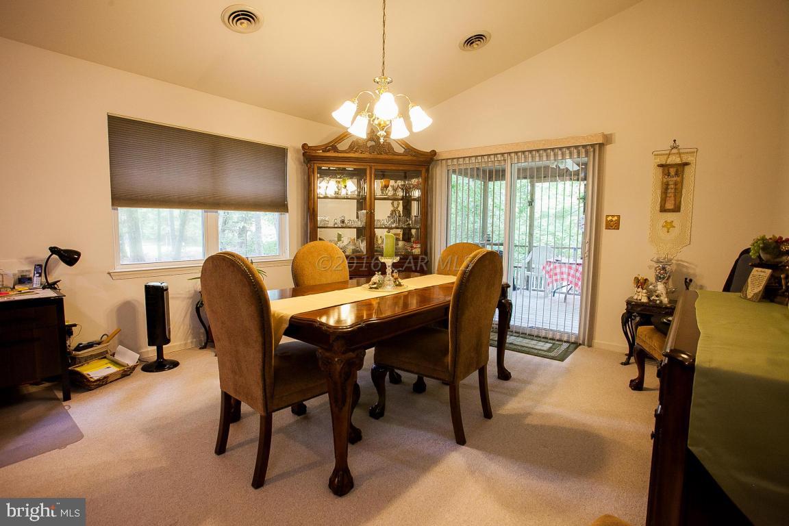 133 Pinehurst Road Berlin, MD 21811 - Photo 31 of 112 a view of a dining room with furniture and a chandelier