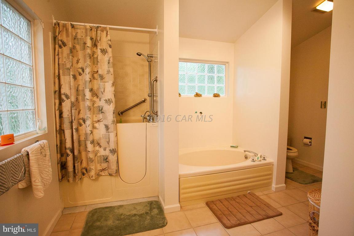 133 Pinehurst Road Berlin, MD 21811 - Photo 57 of 112 a bathroom with a tub shower and a sink