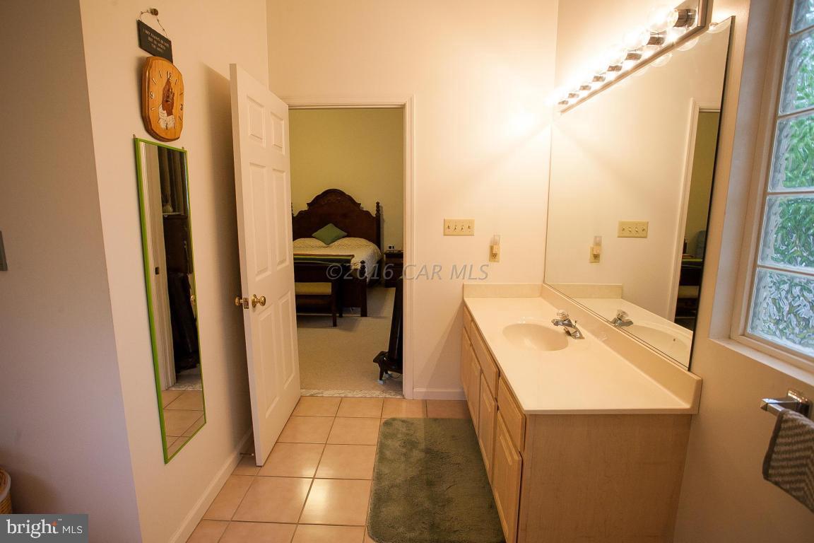 133 Pinehurst Road Berlin, MD 21811 - Photo 77 of 112 a bathroom with a sink a toilet and a mirror