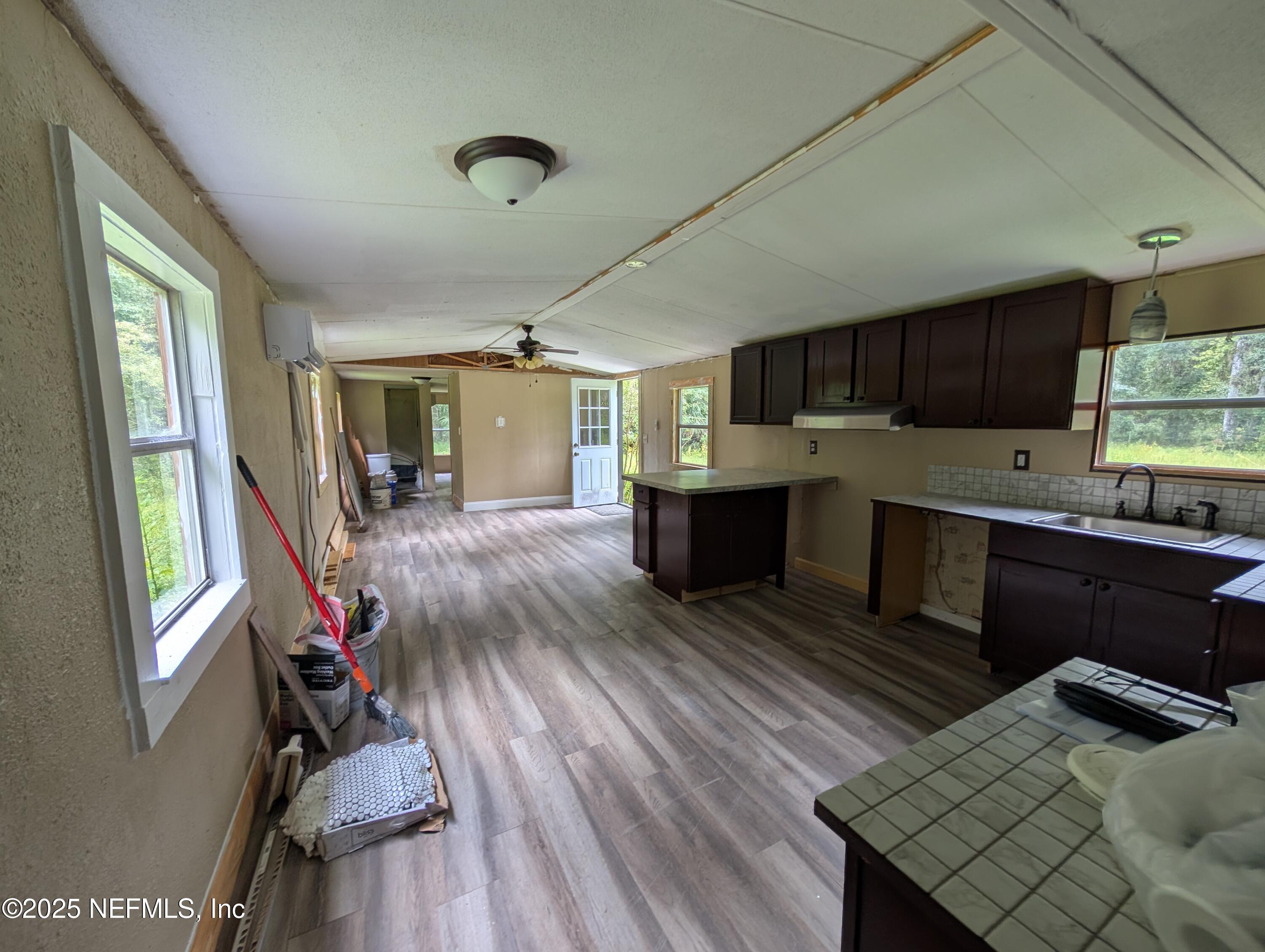 147 Pinetree Road Palatka, FL 32177 - Photo 6 of 17 a kitchen with granite countertop a stove refrigerator and wooden floor
