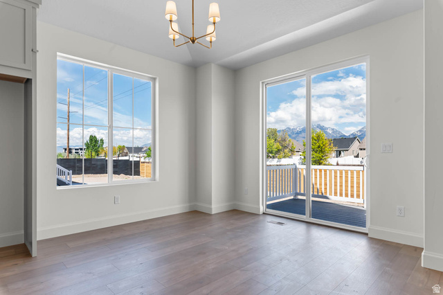 11749 South Halls Crk Road Draper, UT 84020 - Photo 13 of 21 Unfurnished dining area featuring a chandelier, dark wood-type flooring, and plenty of natural light