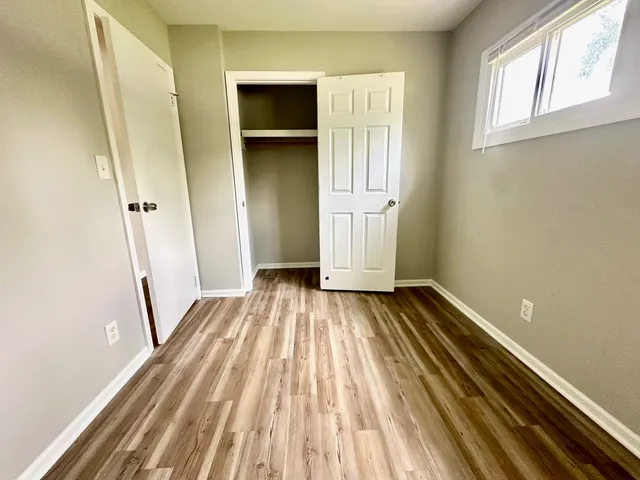 a view of a room with wooden floor and staircase