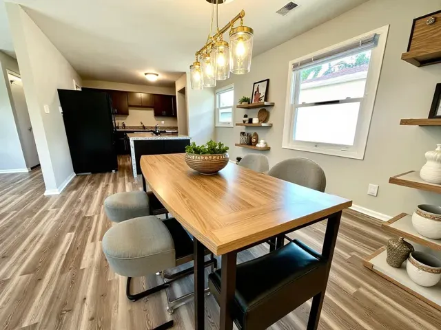 a view of a dining room with furniture window and wooden floor