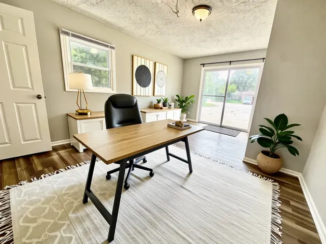 a living room with furniture and a potted plant