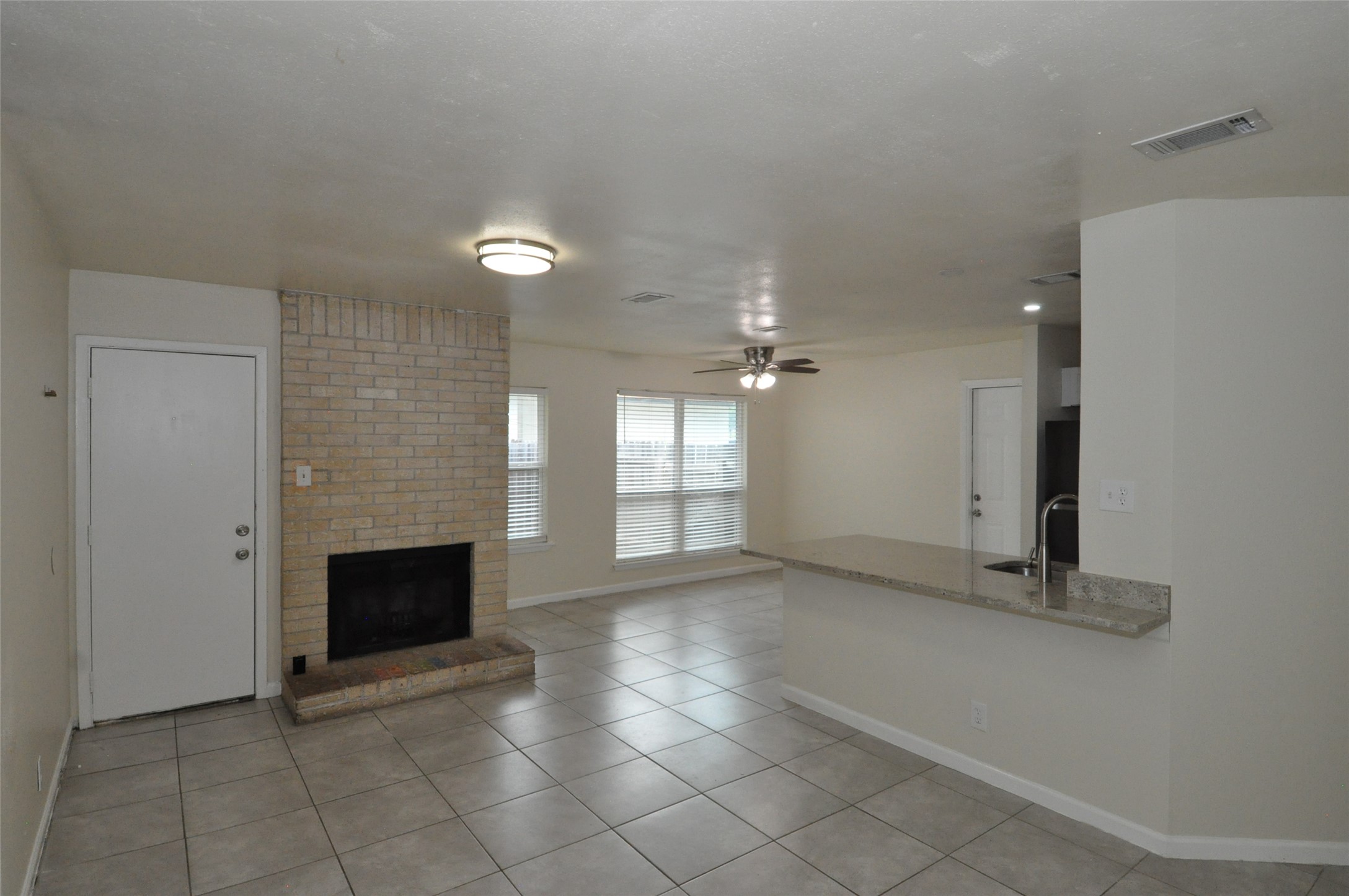 9910 Brasher Drive, Unit B Austin, TX 78748 - Photo 11 of 11 an empty room with fireplace and windows