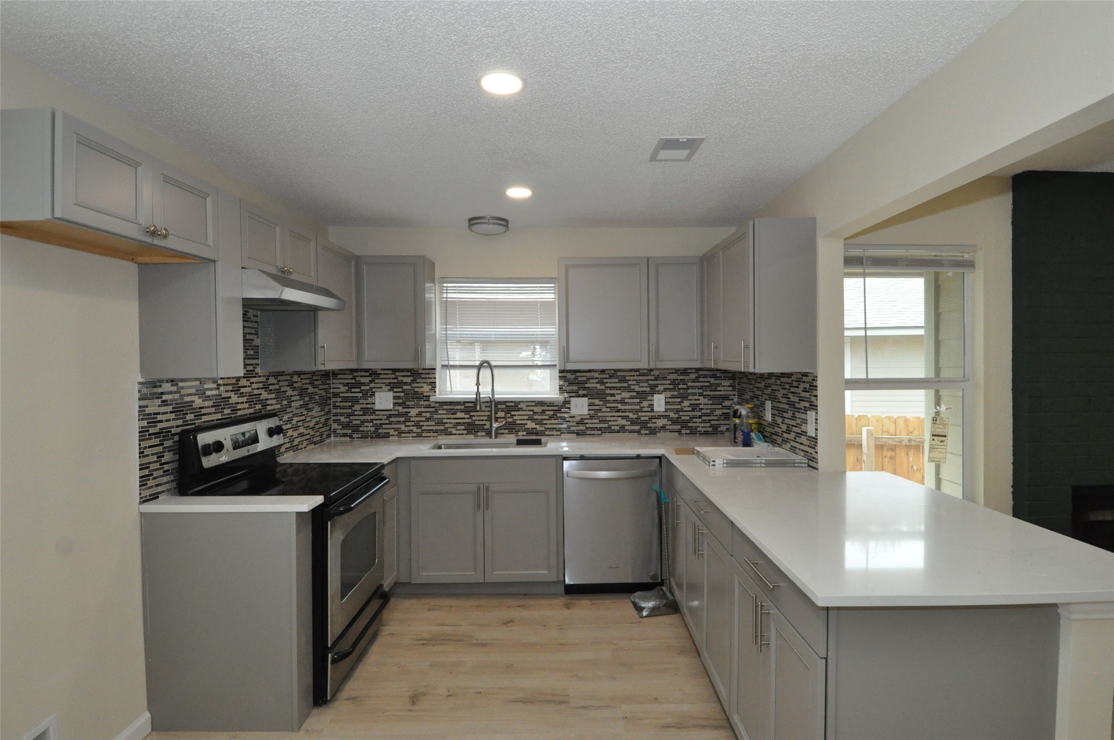 9910 Brasher Drive, Unit B Austin, TX 78748 - Photo 2 of 11 a kitchen with a sink stove and cabinets