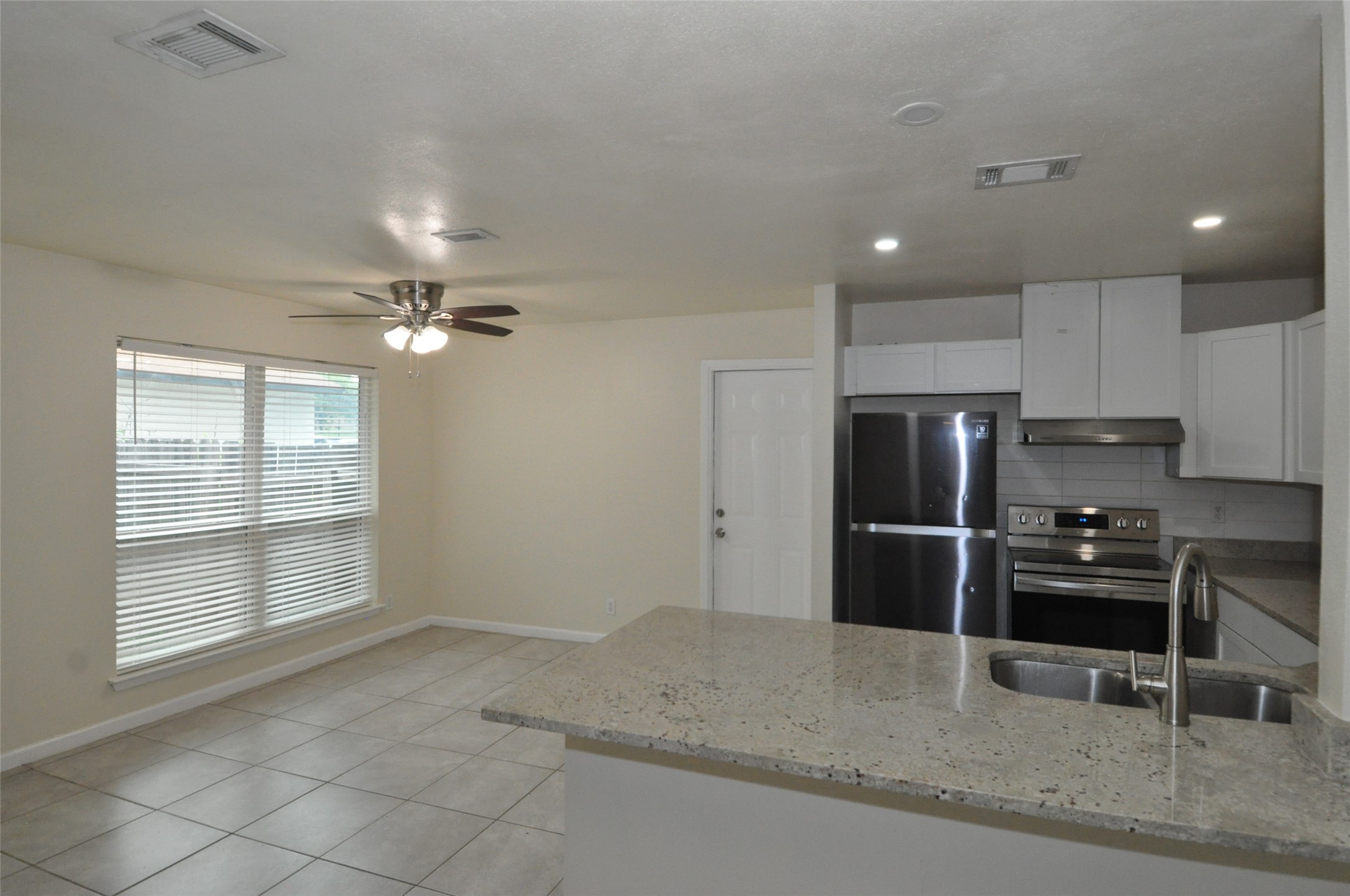9910 Brasher Drive, Unit B Austin, TX 78748 - Photo 3 of 11 a view of a kitchen with refrigerator and chairs