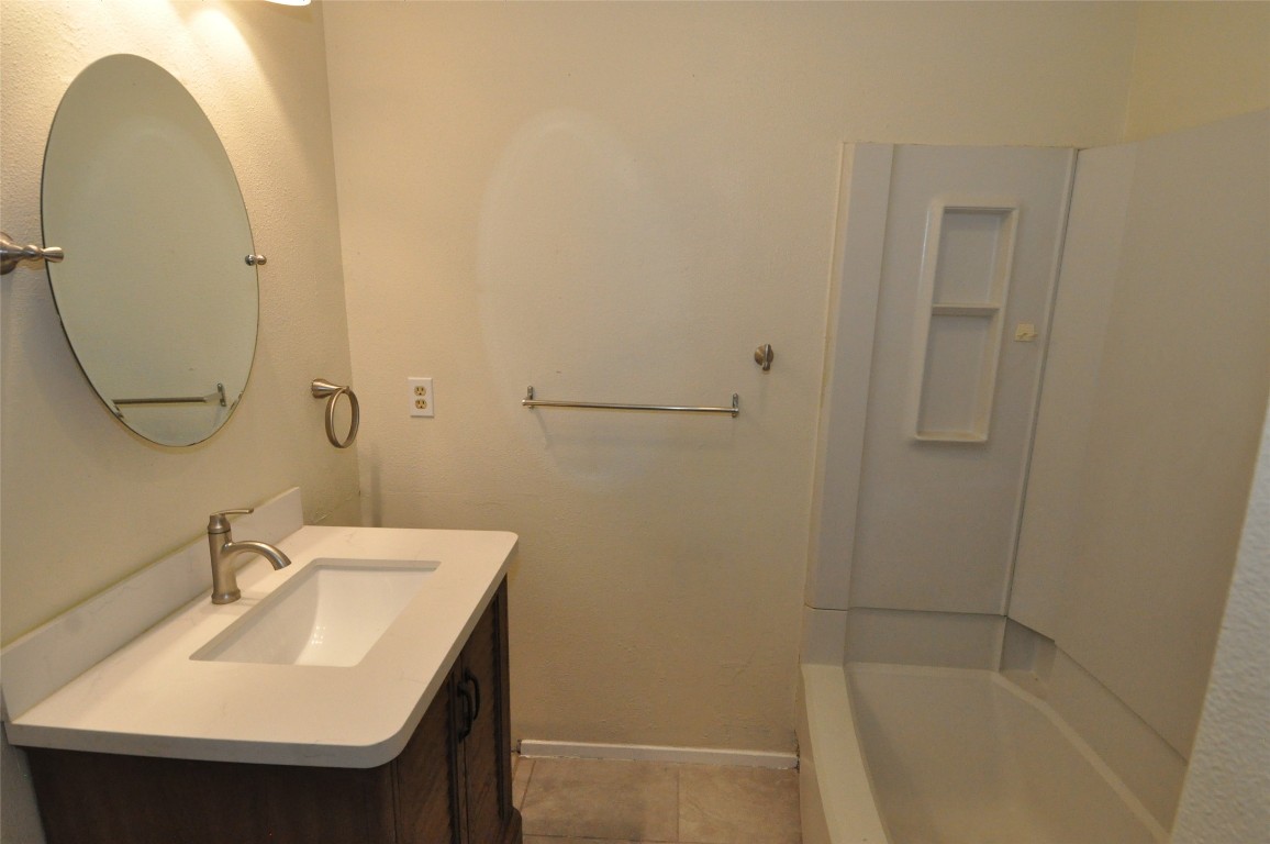 9910 Brasher Drive, Unit B Austin, TX 78748 - Photo 8 of 11 a bathroom with a sink and a mirror