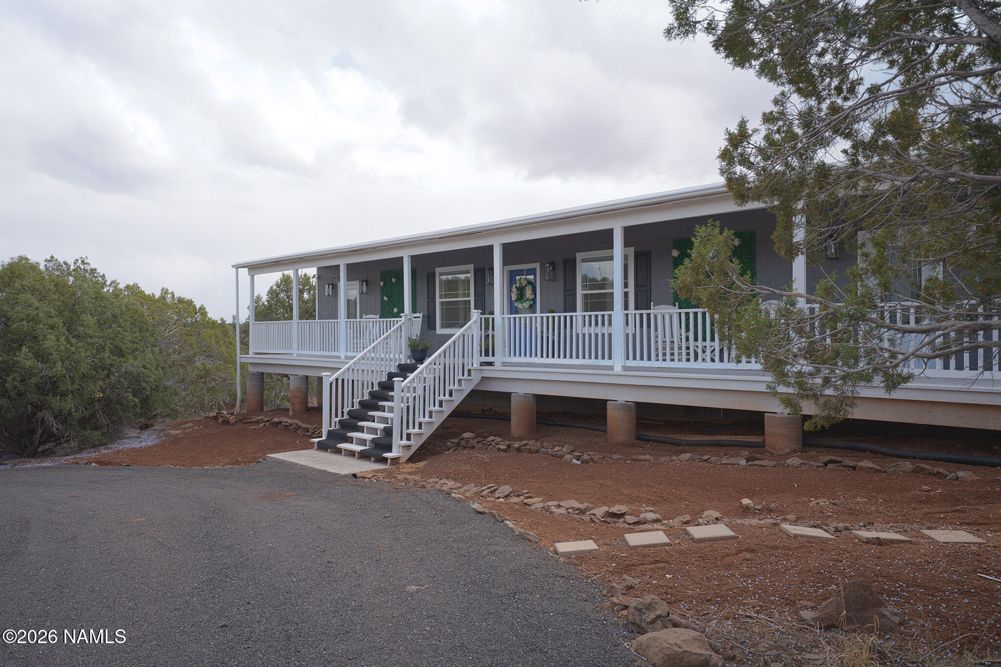 a view of a house with backyard and porch