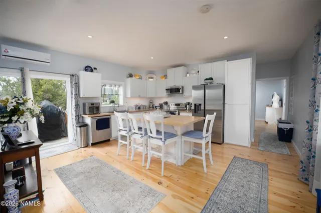 a dining room with furniture and wooden floor