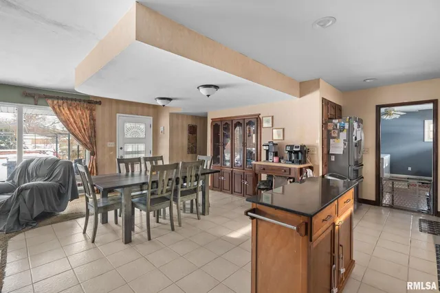 a dining hall with couches a dining table and chairs