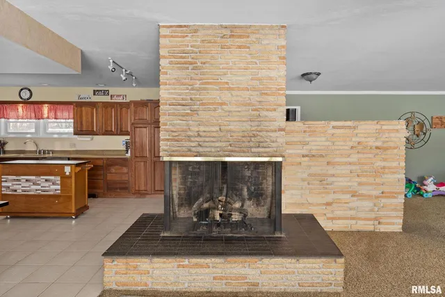a living room with granite countertop furniture and a fireplace