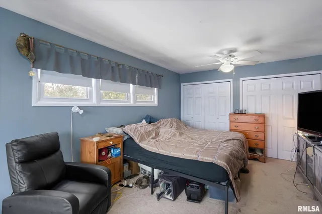 a bedroom with furniture and a flat screen tv