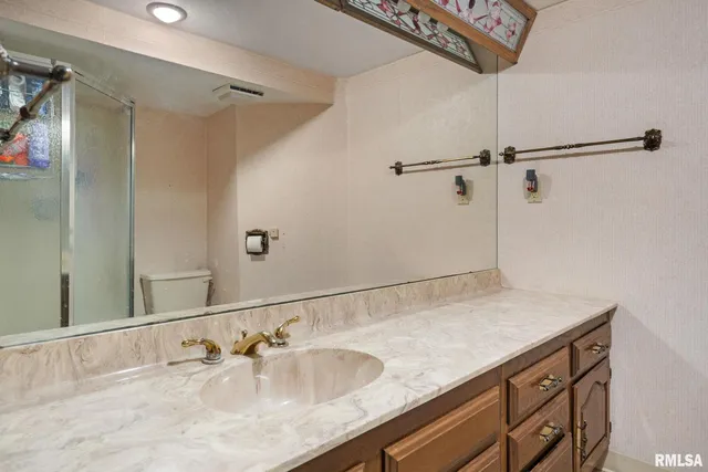 a bathroom with a glass shower door