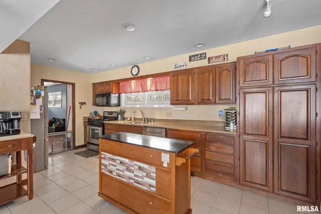 a kitchen with stainless steel appliances granite countertop a stove and a refrigerator