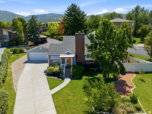 1925 South Main Street Bountiful, UT 84010 - Photo 42 of 48 Traditional-style home featuring a prominent brick chimney, an attached garage, and a concrete driveway