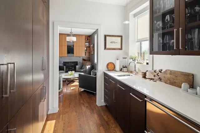 a kitchen with a sink appliances and cabinets