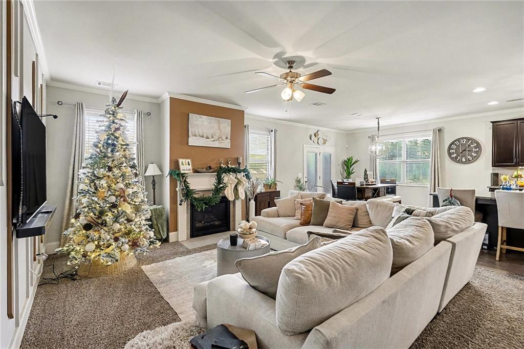 7284 Demeter Atlanta, GA 30349 - Photo 12 of 33 a living room with furniture a chandelier and a flat screen tv