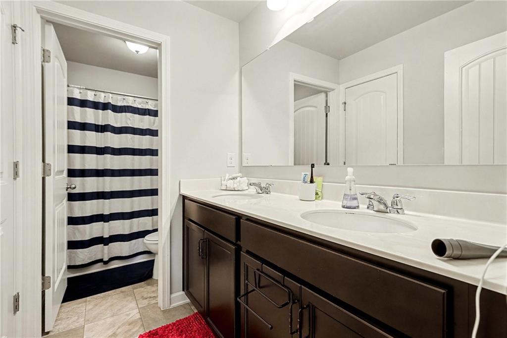 7284 Demeter Atlanta, GA 30349 - Photo 15 of 33 a bathroom with a sink and a mirror