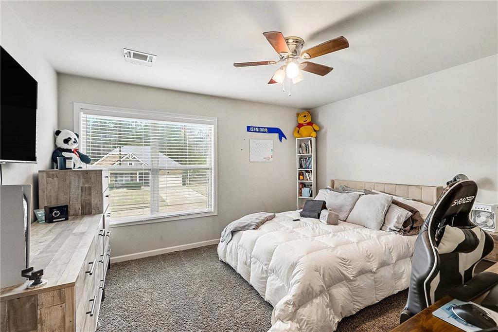 7284 Demeter Atlanta, GA 30349 - Photo 18 of 33 a bedroom with a bed and a flat screen tv