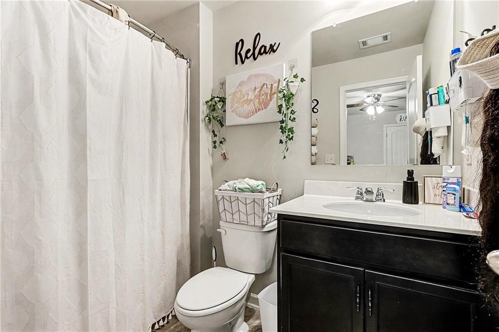 7284 Demeter Atlanta, GA 30349 - Photo 20 of 33 a bathroom with a sink a toilet and shower curtain