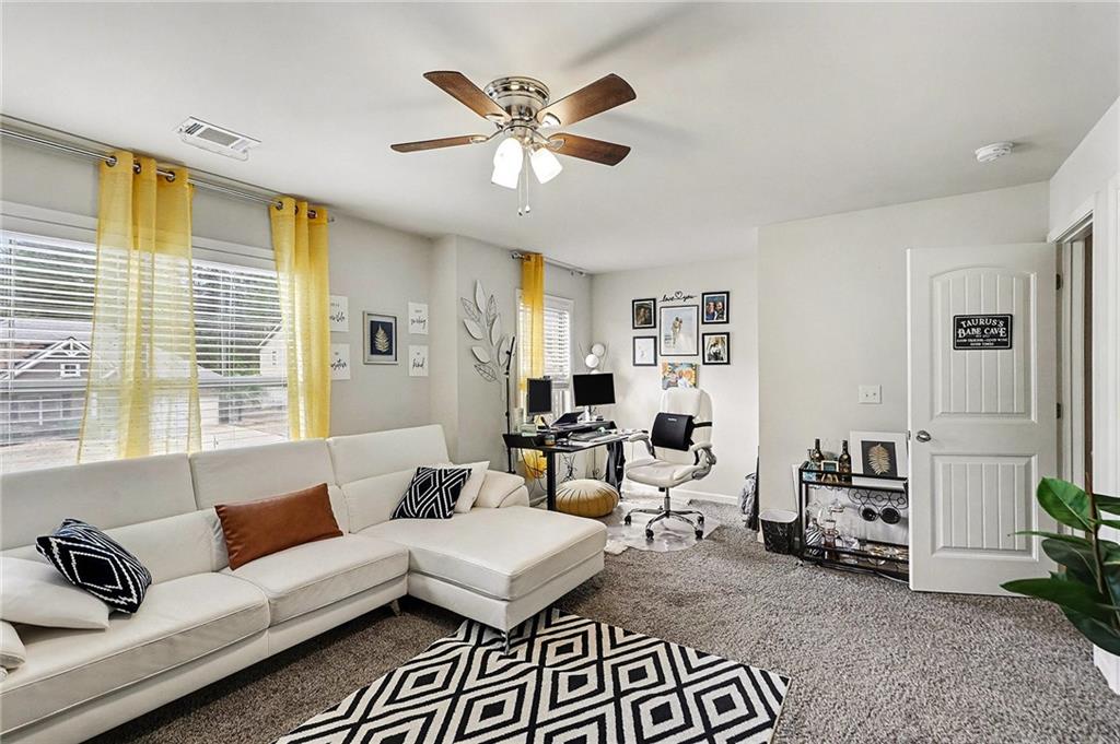 7284 Demeter Atlanta, GA 30349 - Photo 22 of 33 a living room with furniture and a large window