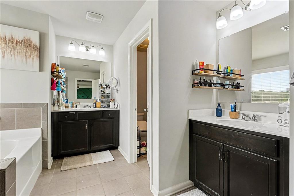 7284 Demeter Atlanta, GA 30349 - Photo 23 of 33 a kitchen with a sink and cabinets