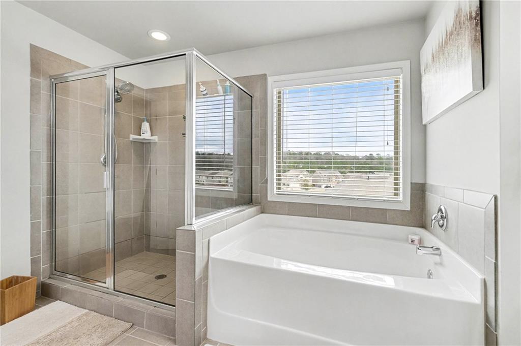 7284 Demeter Atlanta, GA 30349 - Photo 24 of 33 a bathroom with a bathtub and shower