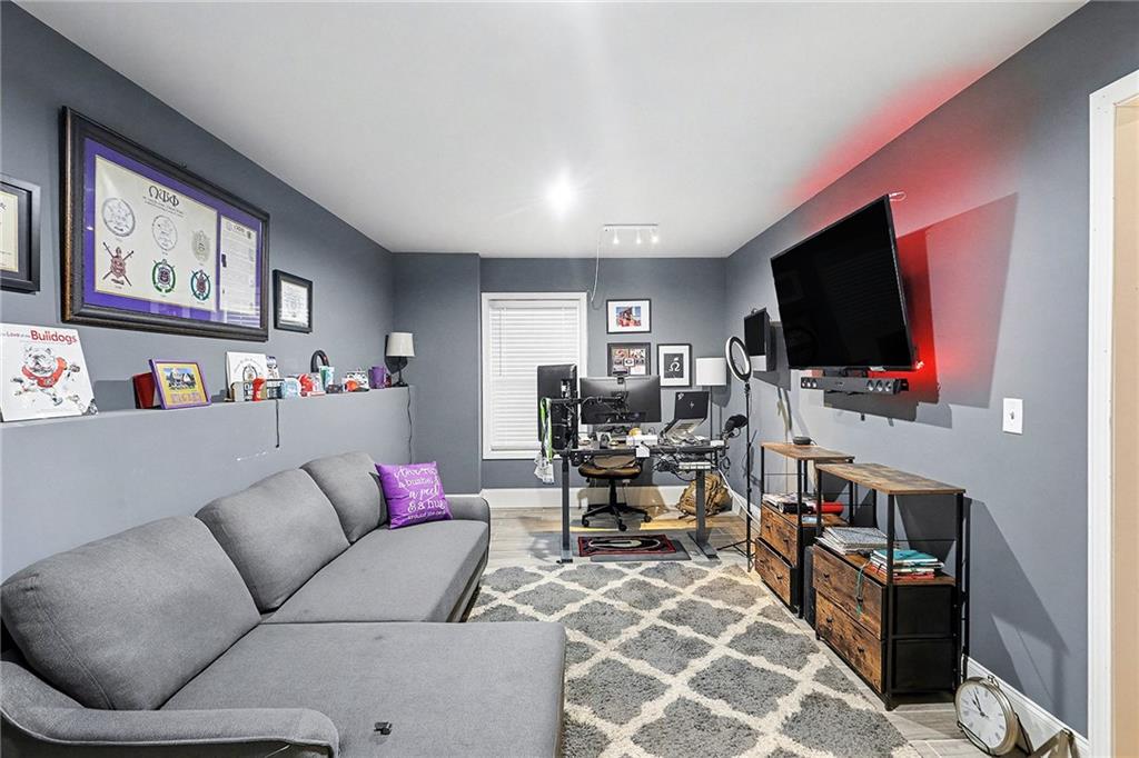 7284 Demeter Atlanta, GA 30349 - Photo 29 of 33 a living room with furniture and a flat screen tv