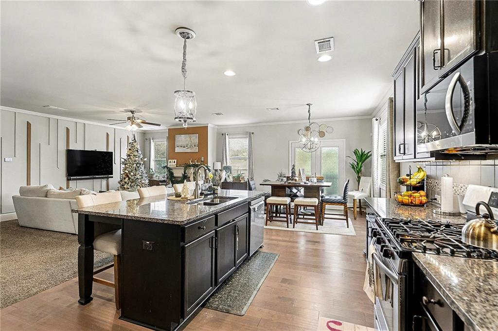 7284 Demeter Atlanta, GA 30349 - Photo 4 of 33 a kitchen with lots of counter top space and stainless steel appliances