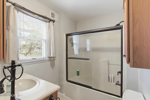 a bathroom with a sink a mirror and a shower