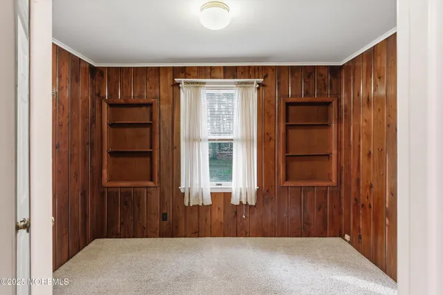 a view of hallway with wooden floor and stairs