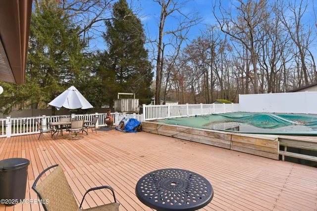 a view of a dinning table and chairs on roof deck