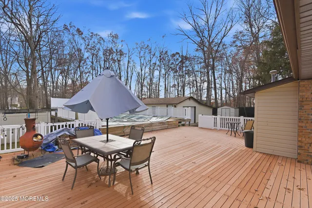 a view of a house with backyard and wooden fence