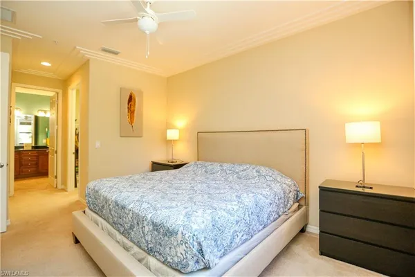 a bedroom with a bed and a lamp