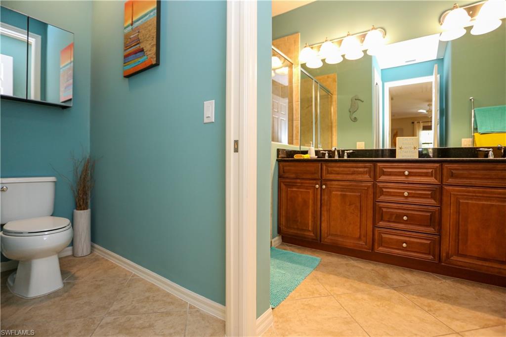 9082 Capistrano Street North, Unit 484 Naples, FL 34113 - Photo 20 of 35 a spacious bathroom with a sink and a mirror