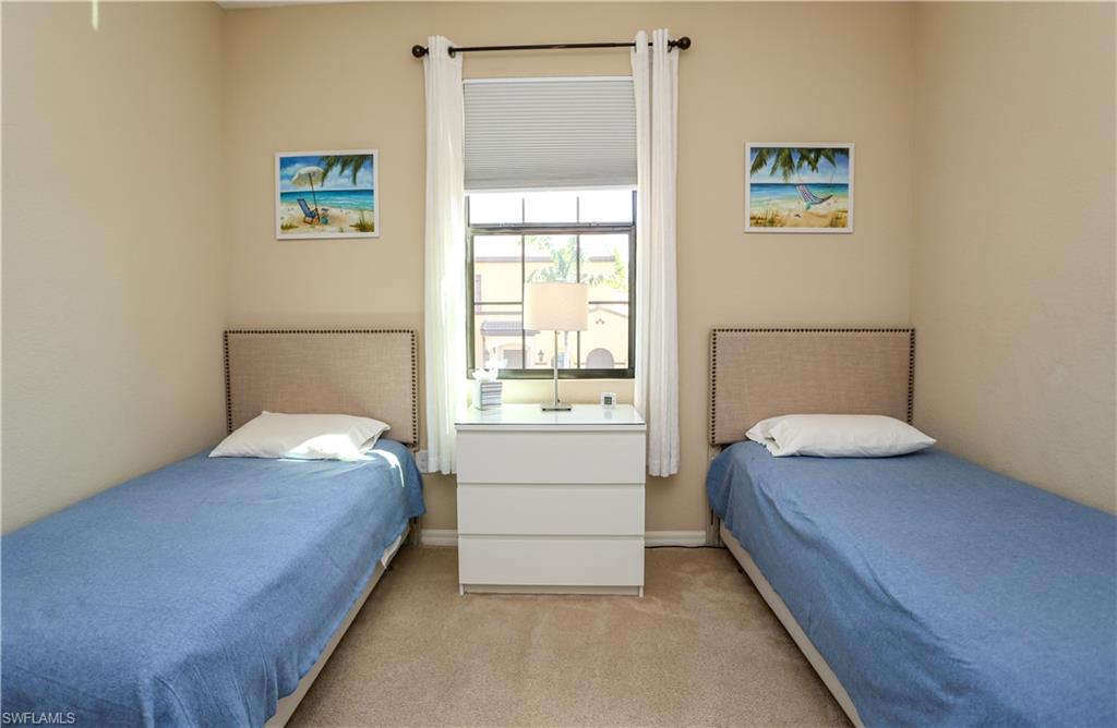 9082 Capistrano Street North, Unit 484 Naples, FL 34113 - Photo 21 of 35 a bedroom with a bed and a window