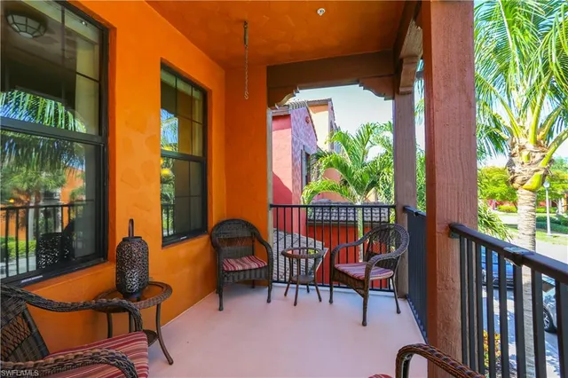 a balcony with chairs and a table