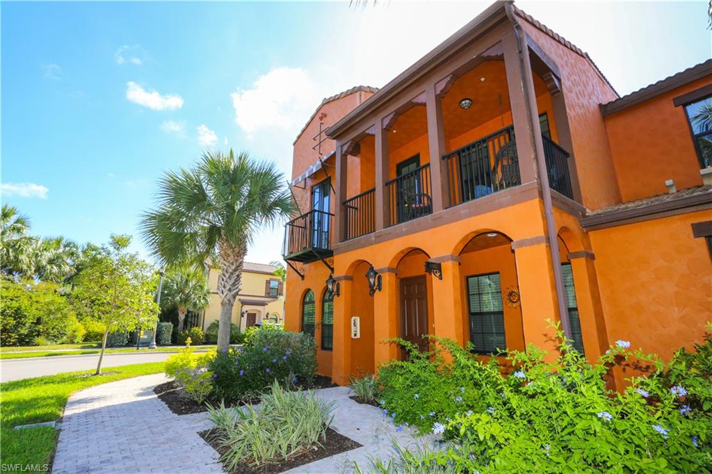 9082 Capistrano Street North, Unit 484 Naples, FL 34113 - Photo 32 of 35 a view of a building with a yard