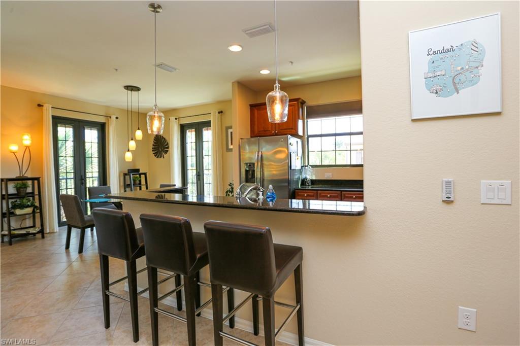 9082 Capistrano Street North, Unit 484 Naples, FL 34113 - Photo 7 of 35 a kitchen with a table and chairs in it