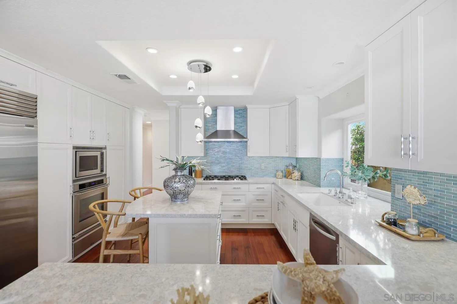 21 Spinnaker Way Coronado, CA 92118 - Photo 13 of 47 a large kitchen with stainless steel appliances kitchen island granite countertop a sink and cabinets