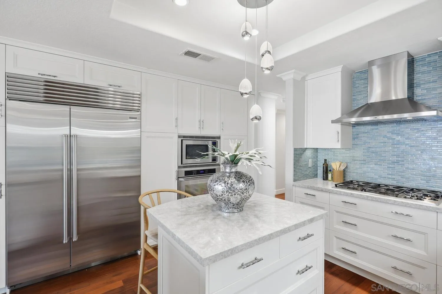 21 Spinnaker Way Coronado, CA 92118 - Photo 15 of 47 a kitchen with kitchen island a counter top a stove a refrigerator and cabinets