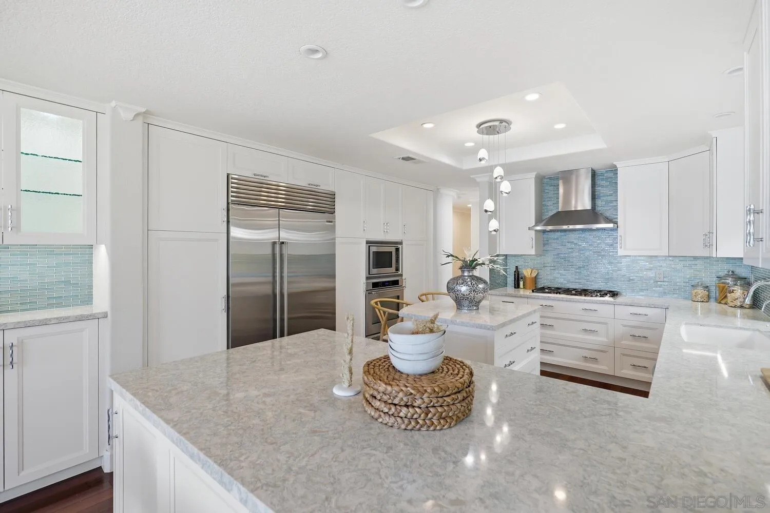 21 Spinnaker Way Coronado, CA 92118 - Photo 17 of 47 a large white kitchen with a granite countertops and a fireplace