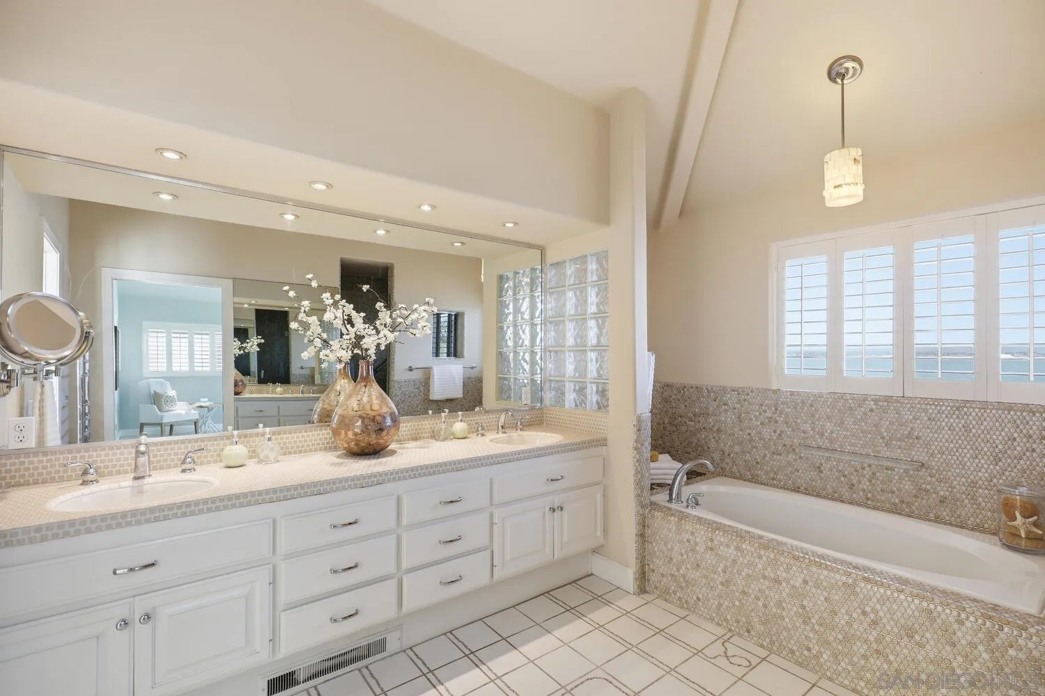 21 Spinnaker Way Coronado, CA 92118 - Photo 38 of 47 a spacious bathroom with a granite countertop sink a mirror a bathtub and next to a window