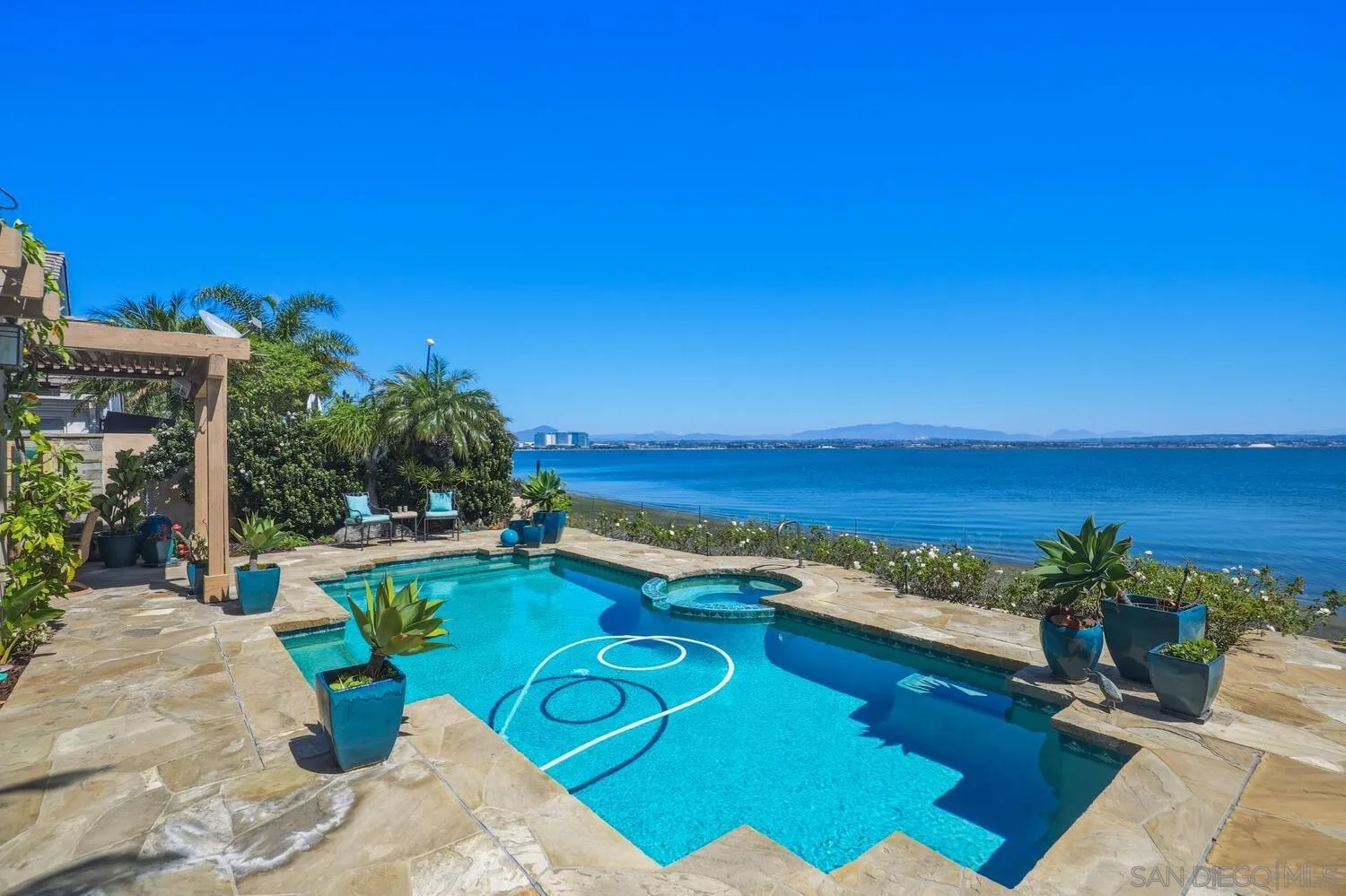21 Spinnaker Way Coronado, CA 92118 - Photo 6 of 47 a view of a swimming pool and lounge chairs